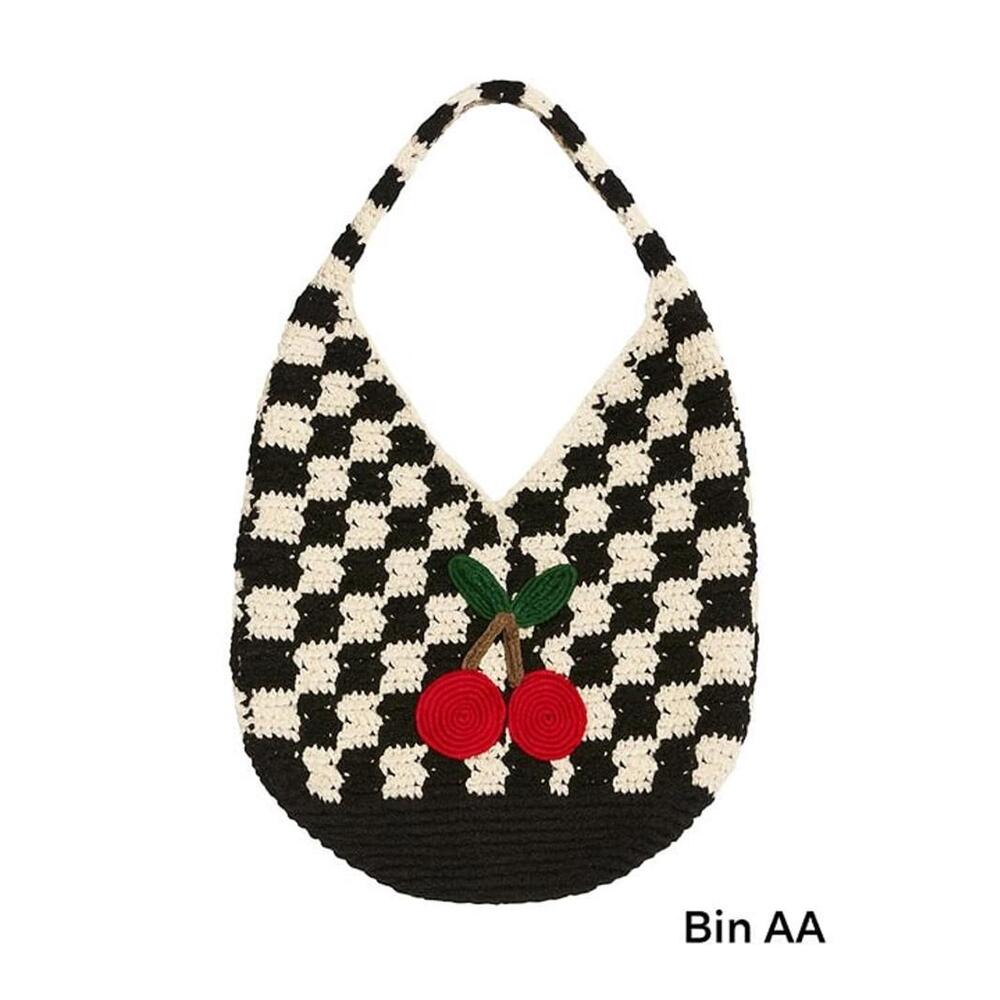 crochet hobo-style shoulder bag in a bold black-and-cream checkerboard pattern.